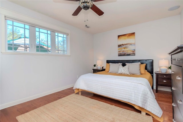 bedroom with ceiling fan and wood-type flooring