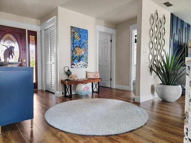 entrance foyer with dark hardwood / wood-style floors