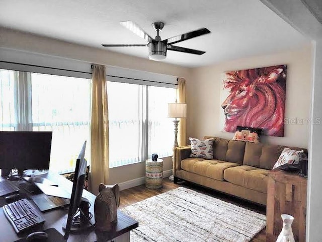 living room featuring hardwood / wood-style flooring, a wealth of natural light, and ceiling fan