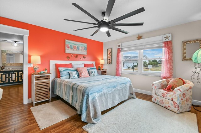 bedroom with ceiling fan and dark hardwood / wood-style floors