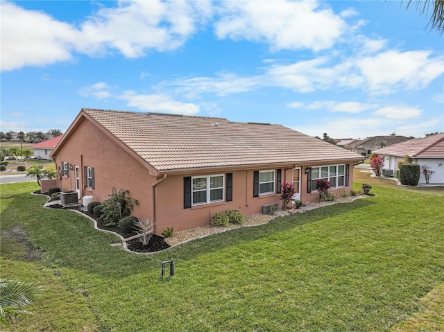 rear view of property with a yard and cooling unit