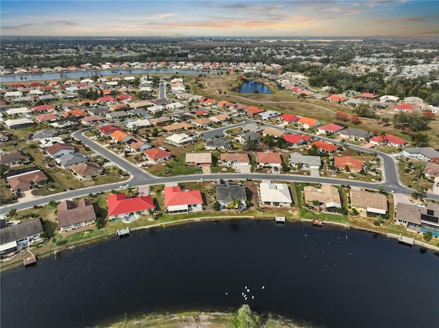 aerial view at dusk with a water view