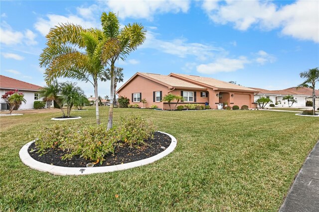 view of front of house featuring a garage and a front yard