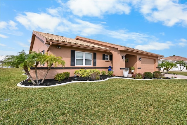 view of front of house featuring a garage and a front lawn