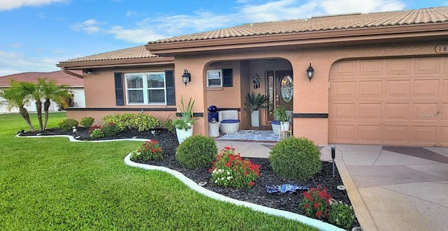 mediterranean / spanish home with a garage and a front yard