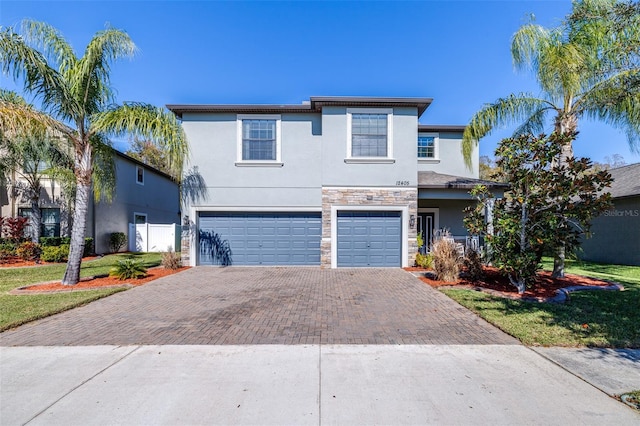 view of front of property with a garage and a front lawn