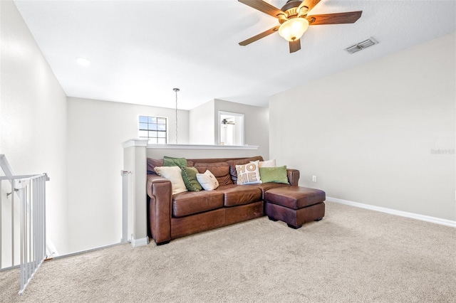 carpeted living room with ceiling fan