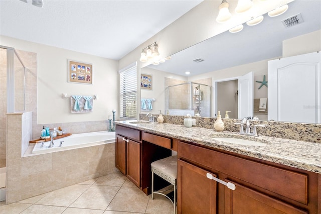 bathroom with tile patterned flooring, vanity, and shower with separate bathtub