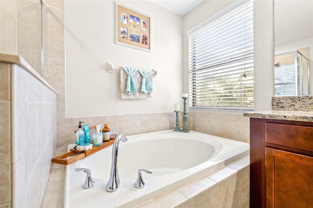 bathroom featuring vanity and separate shower and tub