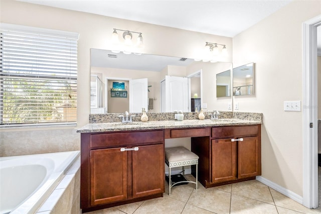 bathroom featuring vanity, tiled bath, and tile patterned floors