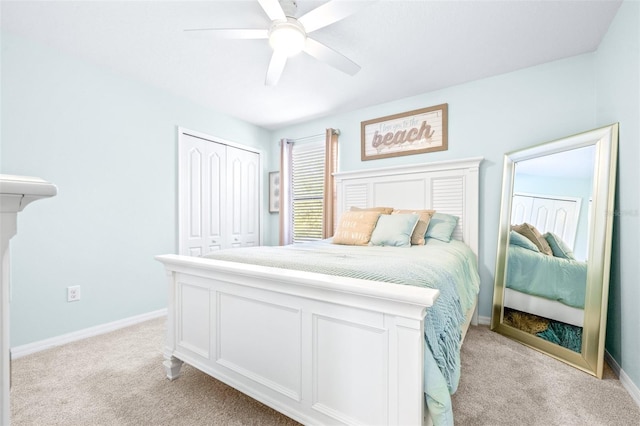 bedroom featuring light carpet, ceiling fan, and a closet