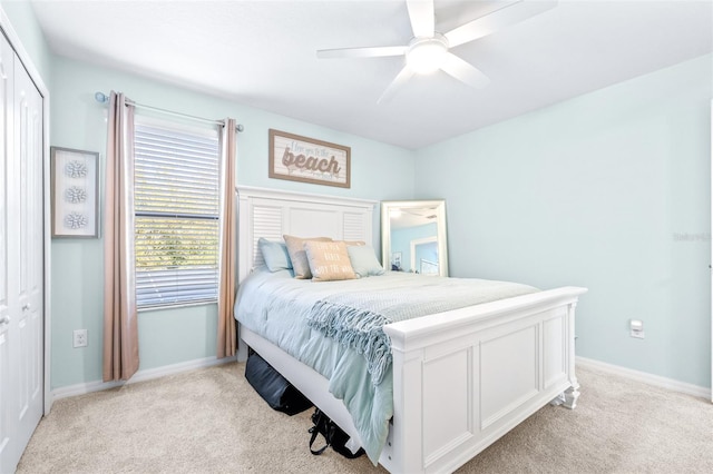 carpeted bedroom featuring ceiling fan and a closet