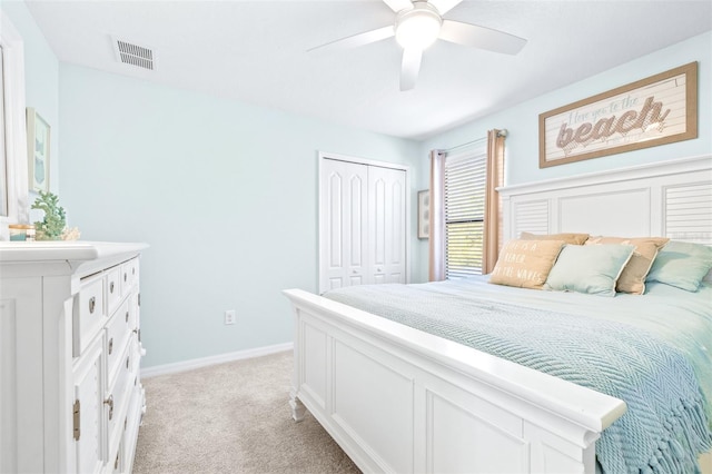 carpeted bedroom with ceiling fan and a closet