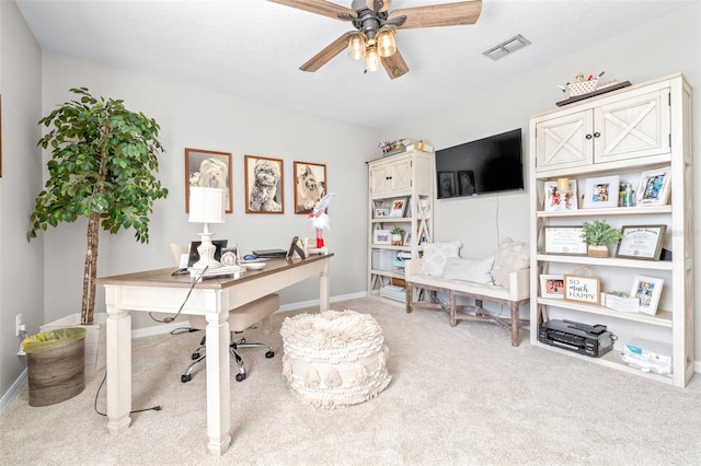 carpeted office with ceiling fan