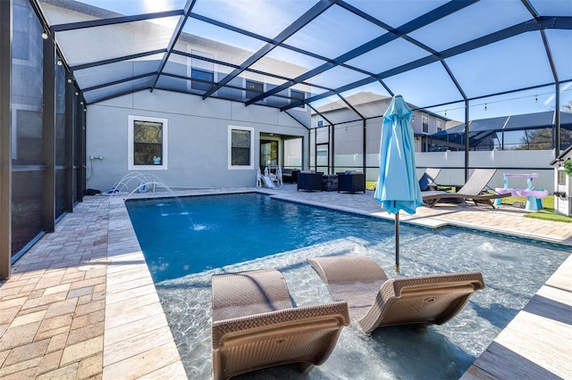 view of pool with pool water feature, a lanai, and a patio area