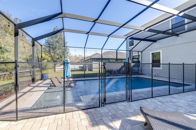 view of swimming pool with pool water feature, a lanai, and a patio area