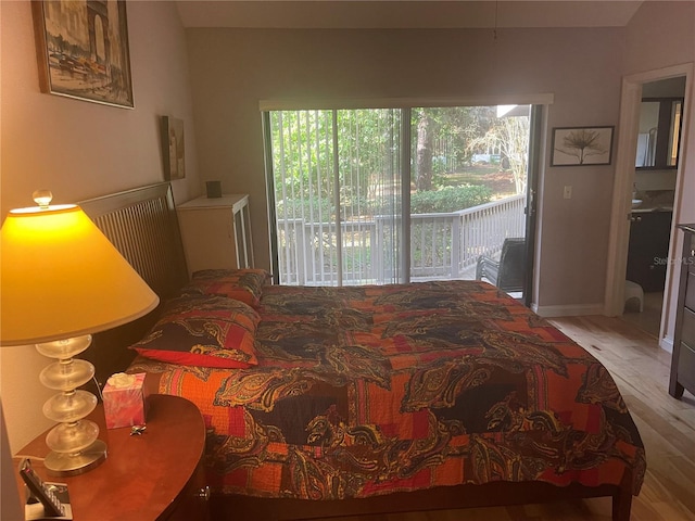 bedroom featuring access to outside and light hardwood / wood-style floors