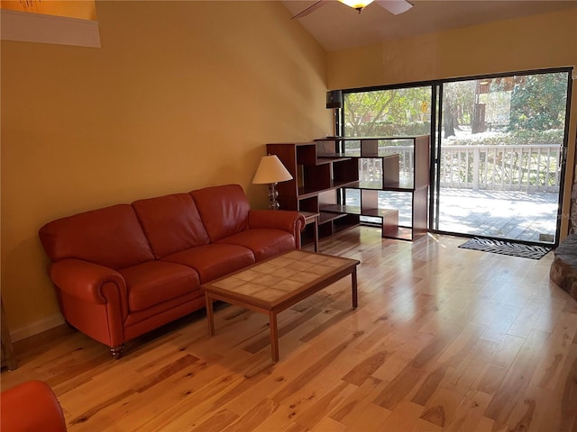 living room with ceiling fan and light hardwood / wood-style flooring