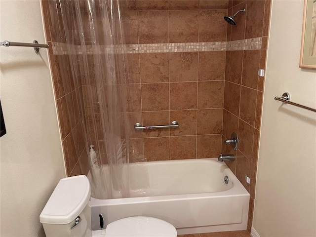 bathroom featuring toilet and shower / bath combo with shower curtain