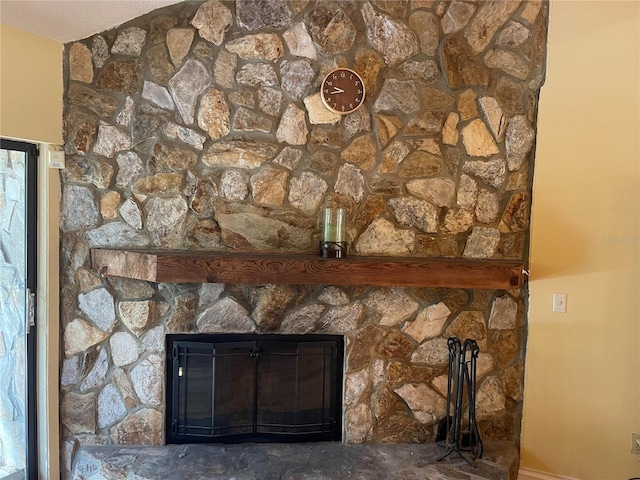 interior details with a stone fireplace