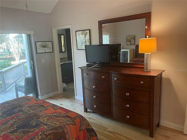 bedroom with access to exterior, connected bathroom, vaulted ceiling, and light hardwood / wood-style flooring