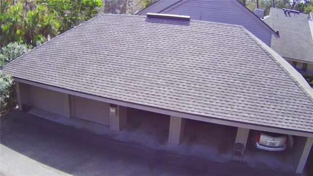 exterior space featuring a shingled roof