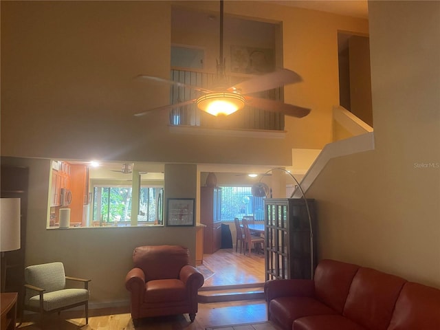 living room with light wood finished floors and a high ceiling