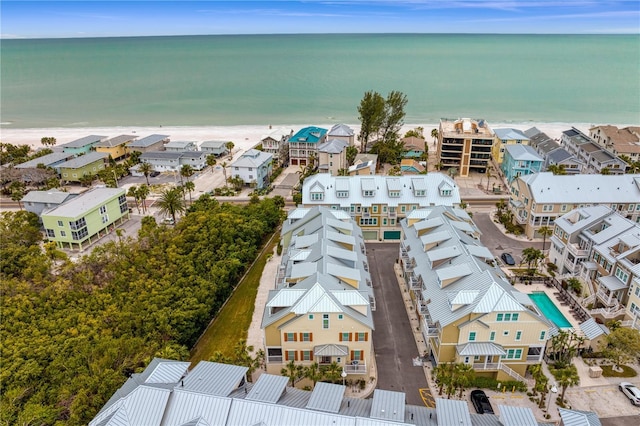 bird's eye view with a water view and a beach view