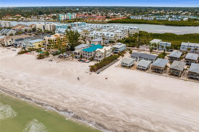 drone / aerial view featuring a beach view and a water view