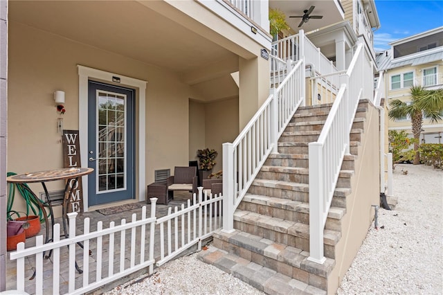 doorway to property featuring ceiling fan