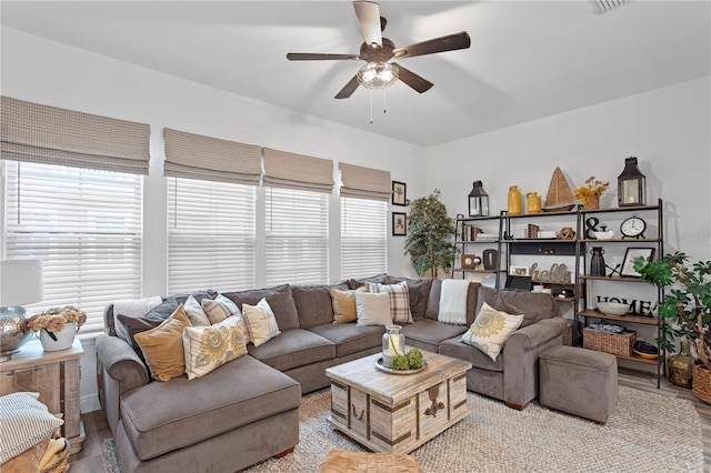 living room featuring light hardwood / wood-style floors and ceiling fan