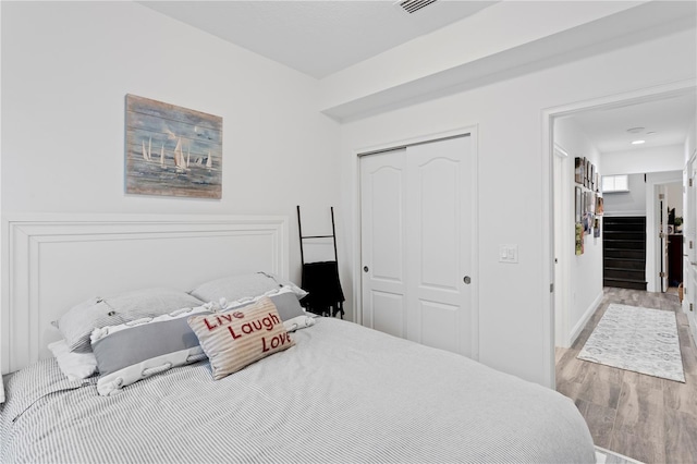 bedroom featuring a closet and light wood-type flooring