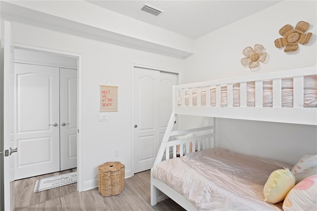 bedroom with hardwood / wood-style floors and a closet