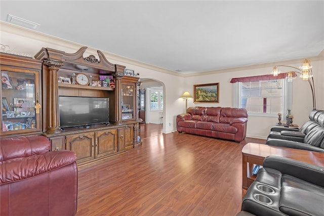 living room featuring wood-type flooring and ornamental molding