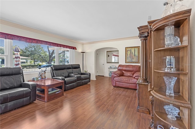 living room featuring wood-type flooring and crown molding