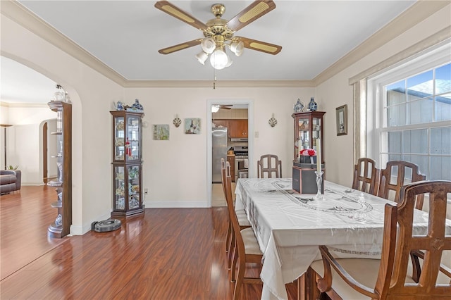 dining space featuring ceiling fan, dark hardwood / wood-style flooring, and ornamental molding