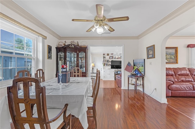 dining area featuring ceiling fan, ornamental molding, and hardwood / wood-style floors