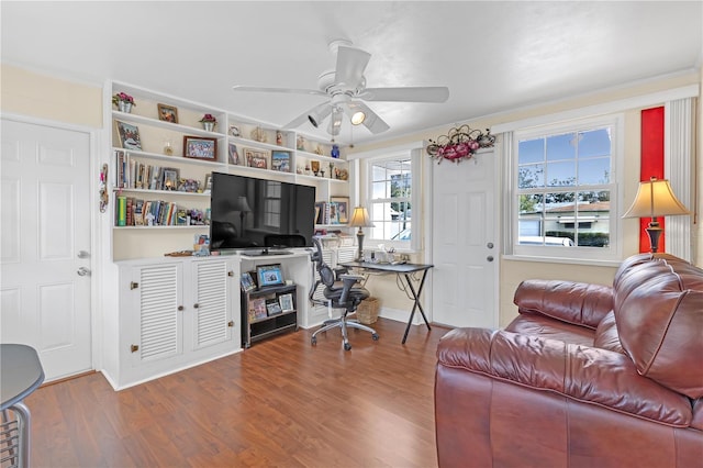 office area with ceiling fan, hardwood / wood-style flooring, and built in shelves