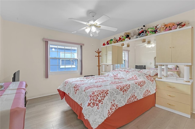 bedroom with ceiling fan and light hardwood / wood-style floors