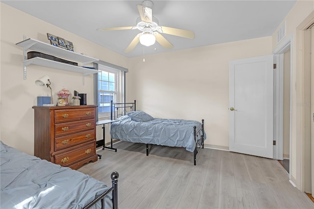 bedroom with ceiling fan and light hardwood / wood-style flooring