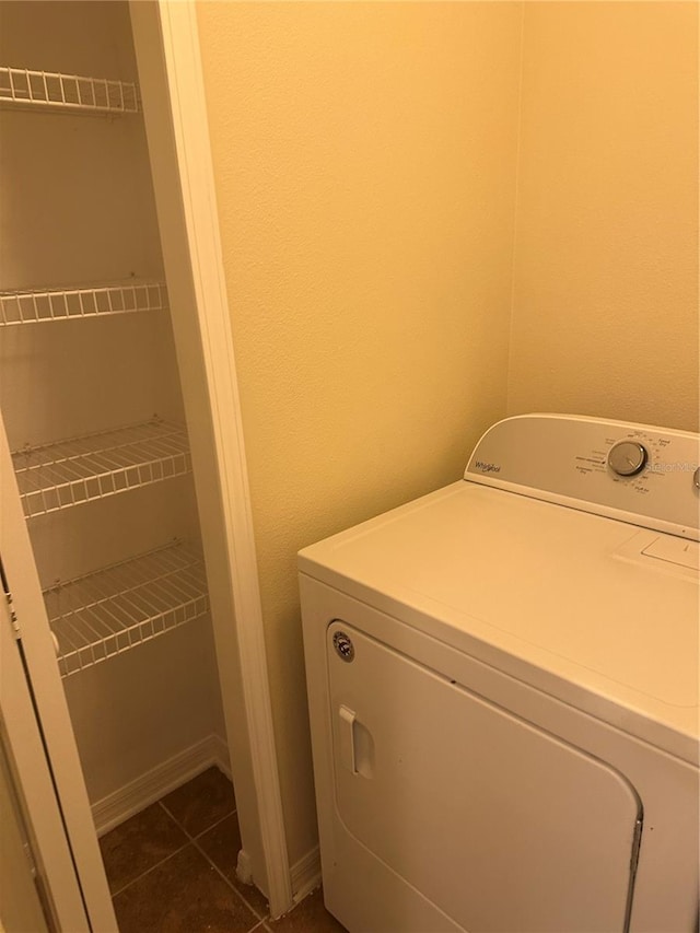 washroom featuring dark tile patterned floors and washer / clothes dryer