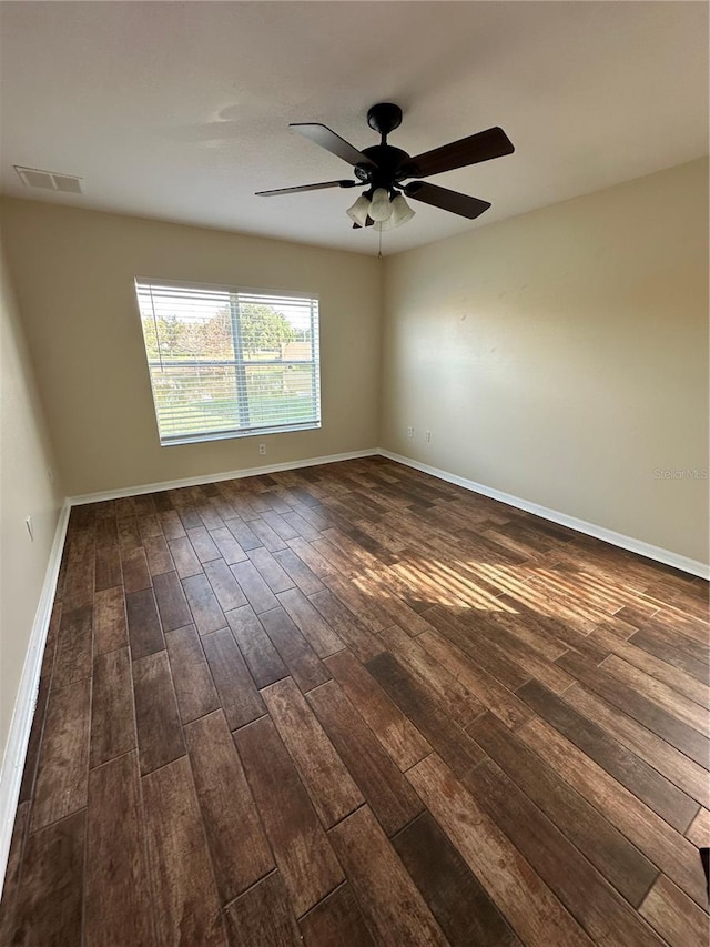 unfurnished room with ceiling fan and dark hardwood / wood-style floors