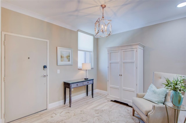 foyer entrance featuring an inviting chandelier and ornamental molding