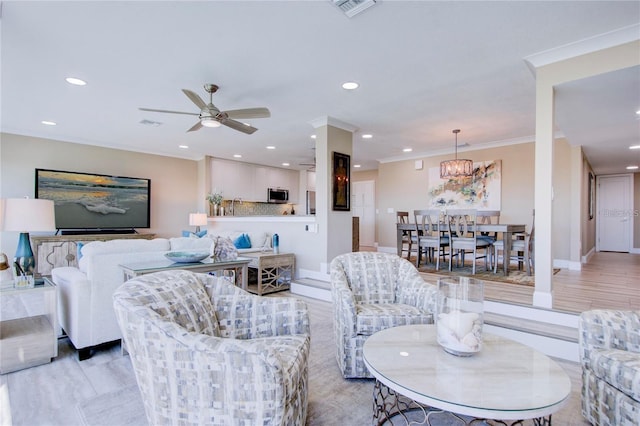 living room with crown molding and ceiling fan