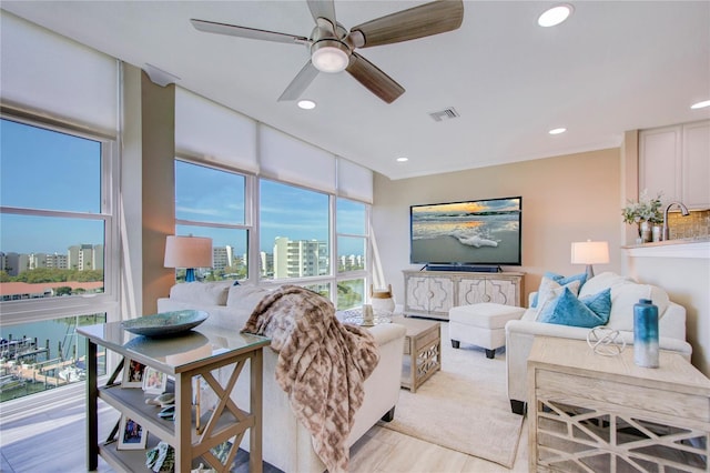 living room featuring ceiling fan and light hardwood / wood-style flooring