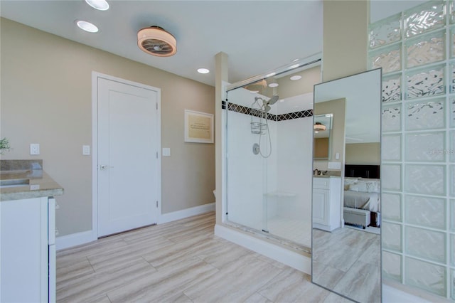 bathroom featuring vanity and an enclosed shower