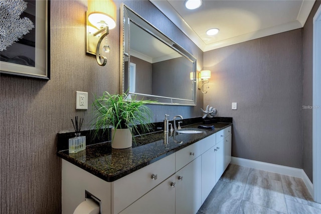 bathroom with crown molding and vanity