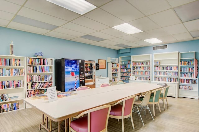 office area with a drop ceiling and light hardwood / wood-style flooring