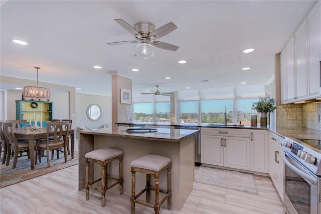 kitchen featuring white cabinetry, appliances with stainless steel finishes, sink, and tasteful backsplash