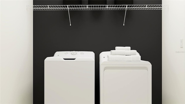 laundry room featuring washing machine and clothes dryer